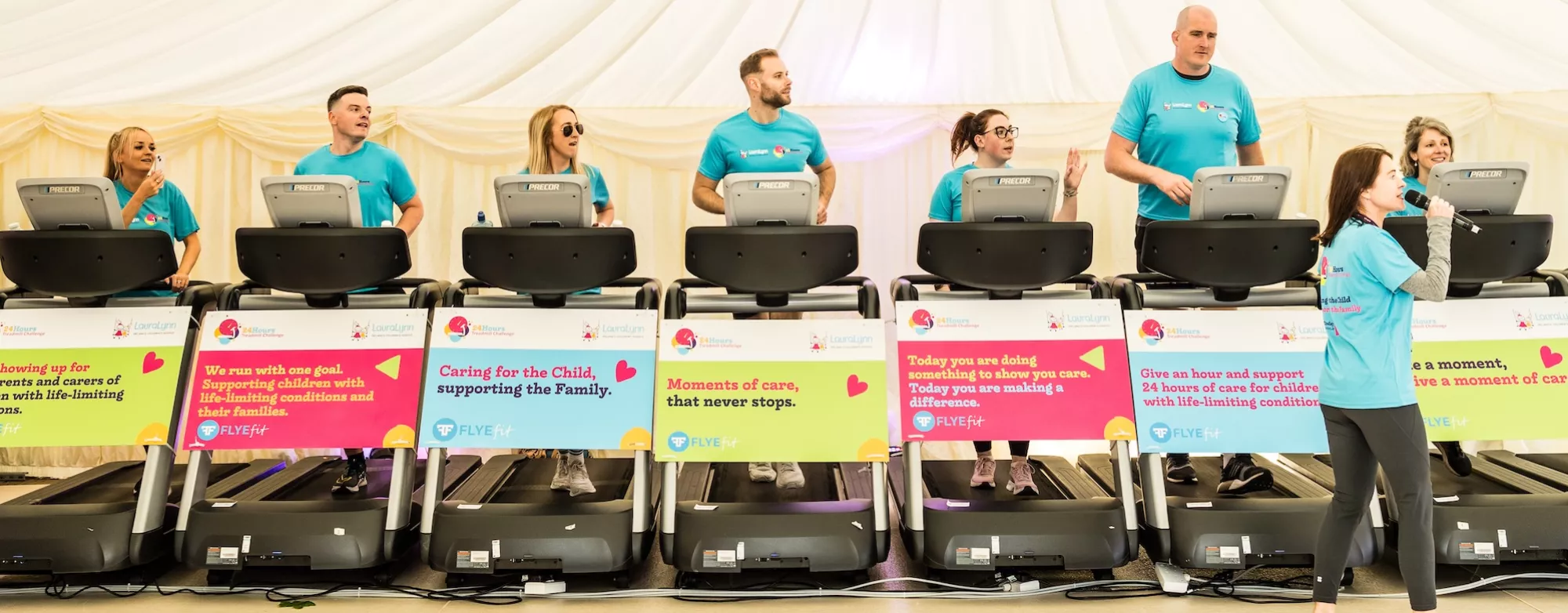 A line of treadmills with an announcer