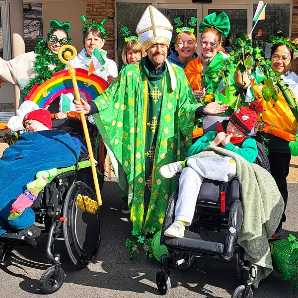 Alan Hughes dressed as St. Patrick, joins LauraLynn children and staff