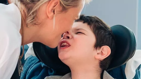 Daniel sharing a kiss with his mum during an event at LauraLynn 