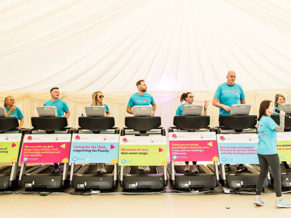 A line of treadmills with an announcer