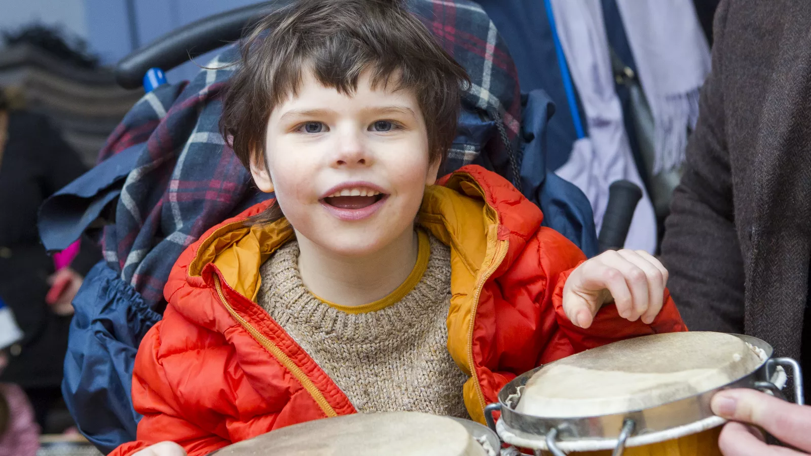 Evan playing the drums and smiling at LauraLynn